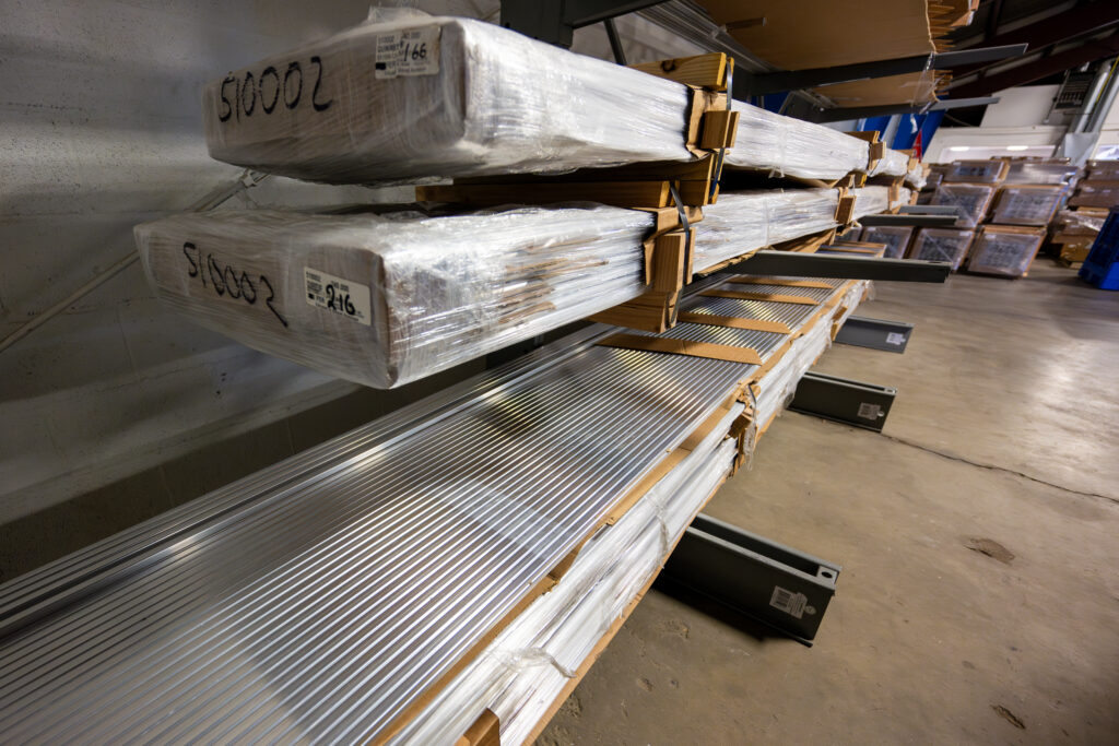 Shelves with stacks of aluminum extrusions