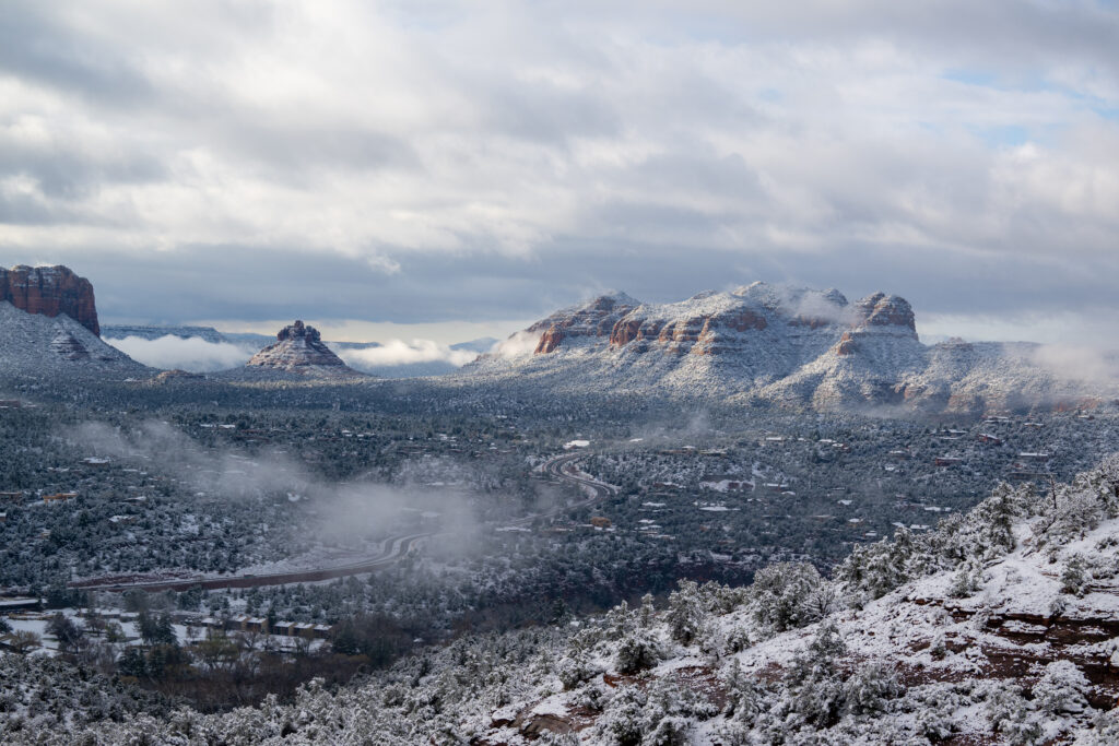 Snow falling over a desert vista in Sedona, Arizona.