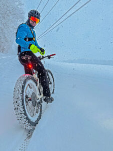 Chris riding a fat tire bike on a snowy day
