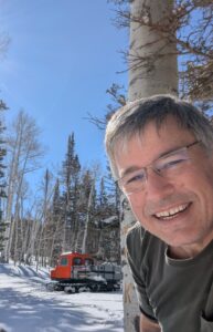 JT Westcott with a snowcat in the background