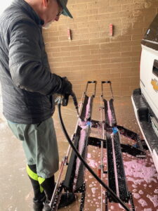 spraying soap on a bike rack