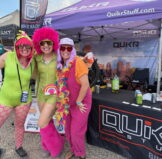 Roam Fest attendees in front of QuikrStuff tent