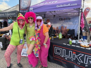 Roam Fest attendees in front of QuikrStuff tent