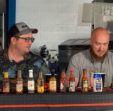 hot sauces lined up for the QuikrStuff Hot Ones challenge