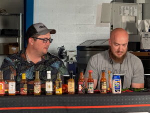 hot sauces lined up for the QuikrStuff Hot Ones challenge