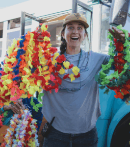 Sam Ryan with leis on arms