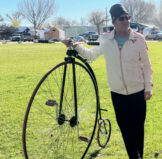Tim next to his Penny Farthing bicycle